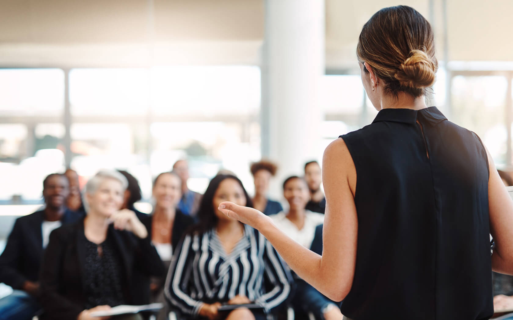 woman speaking in front of an audience