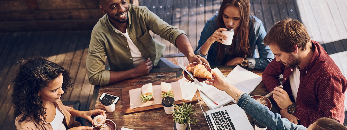 a man serving a croissant to a woman