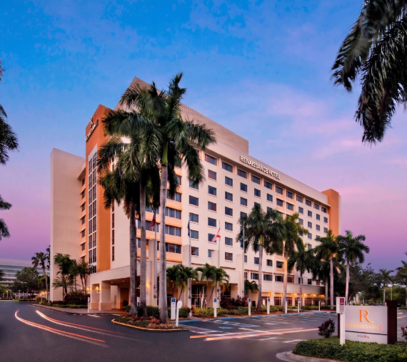 a large building with palm trees