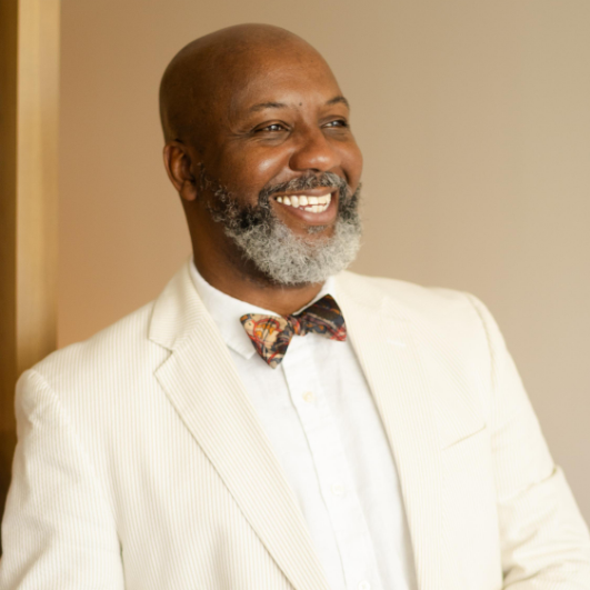 a man in a suit smiling