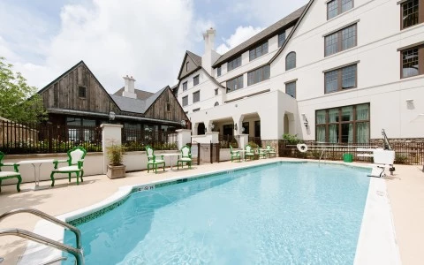 a swimming pool with chairs around it