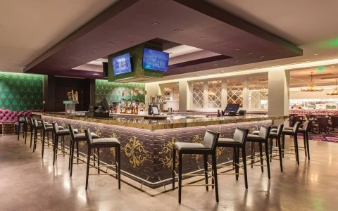 a large room with a bar and chairs