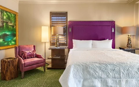 a bedroom with a bed and a chair