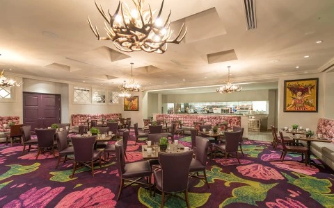 a room with a chandelier and chairs