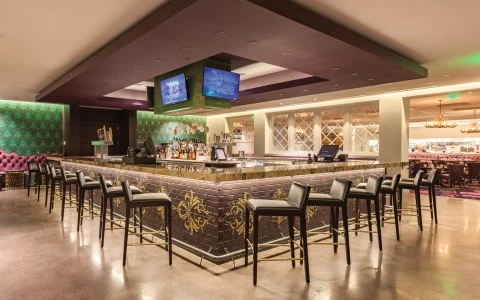 a large room with a bar and chairs