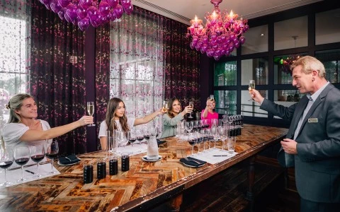 a group of people sitting at a table with wine glasses