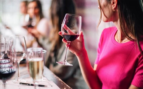 a woman holding a glass of wine