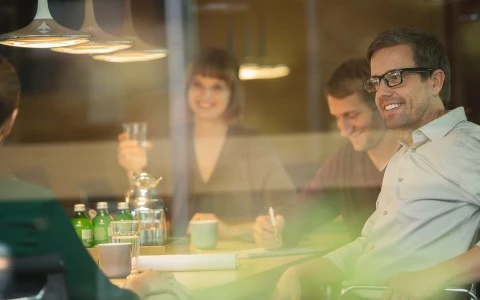 a group of people sitting at a table with drinks