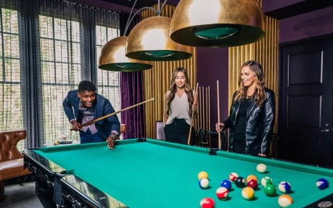 a group of people playing pool