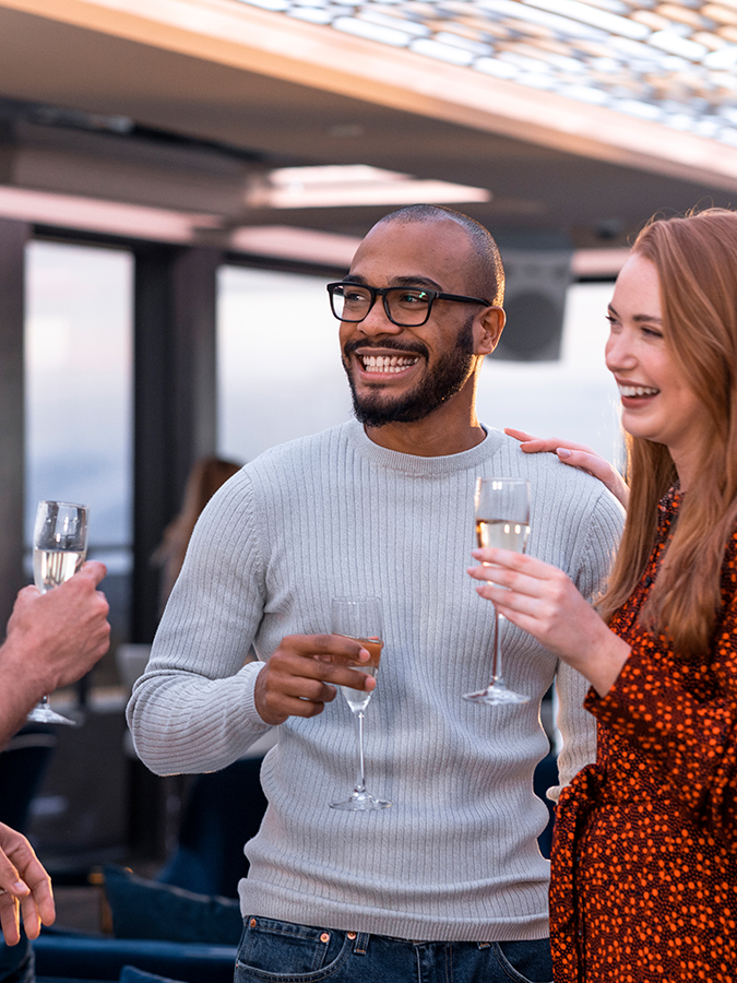 a man and woman holding wine glasses