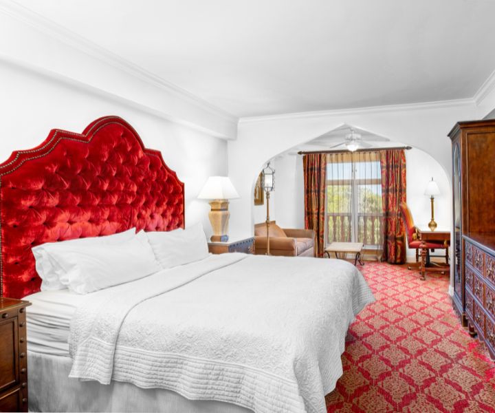 a room with a bed and a red headboard