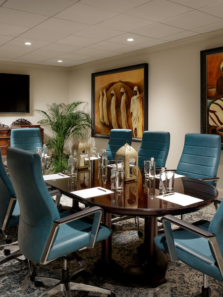 a room with a table and blue chairs