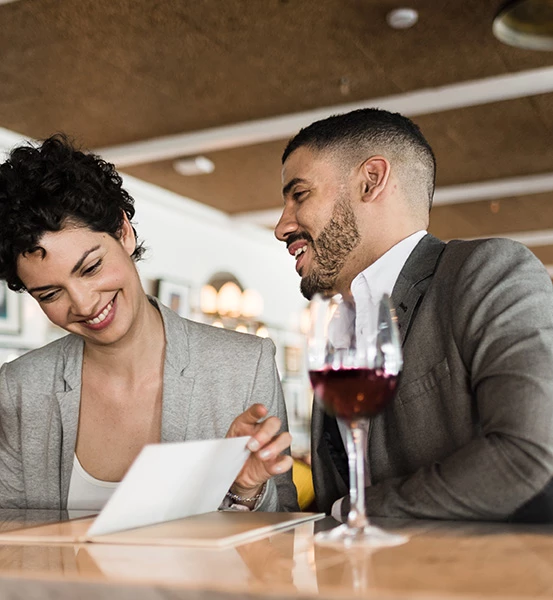 two people talking with a drink