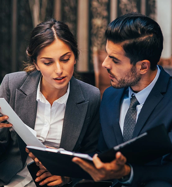 two people reviewing a folder