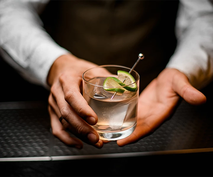 a person holding a glass with a plant in it