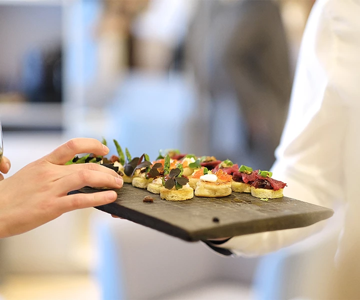a person holding a plate of food