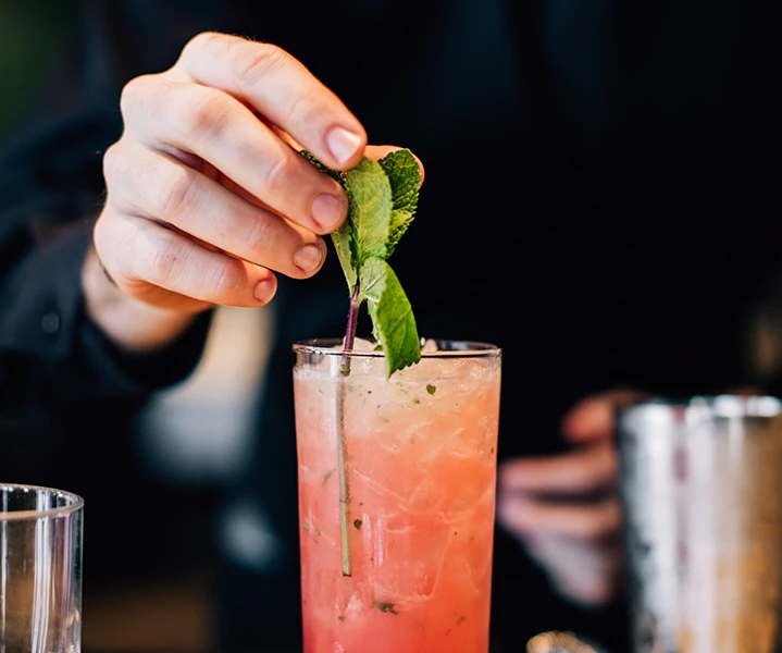 a person holding a a glass with a drink in it