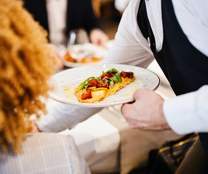 a person holding a plate of food