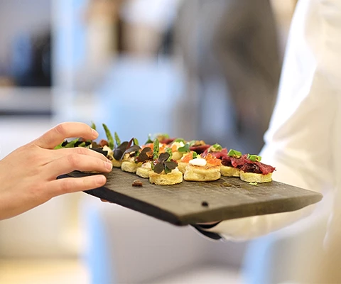 a person holding a plate of food