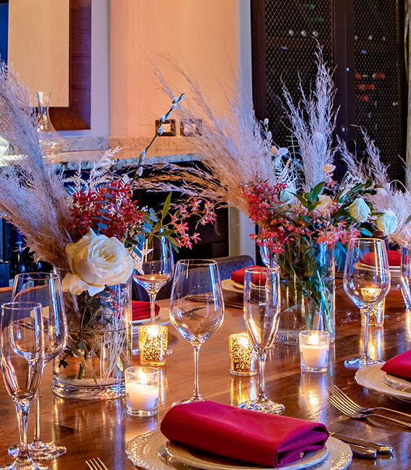 a table with glasses and candles