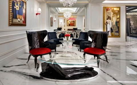 Marbled floors, with black and red chairs 