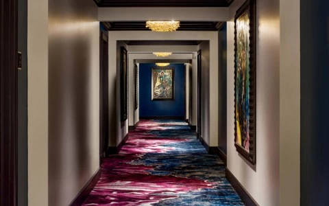 Hotel hallways with purple and blue carpet 