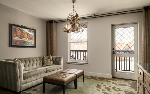 suite with a living room space with a chandelier and a couch
