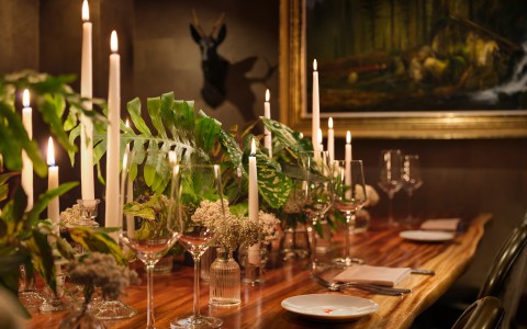 a table with wine glasses and candles