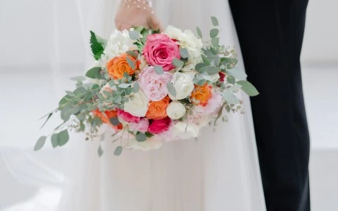 a man and woman holding a bouquet of flowers