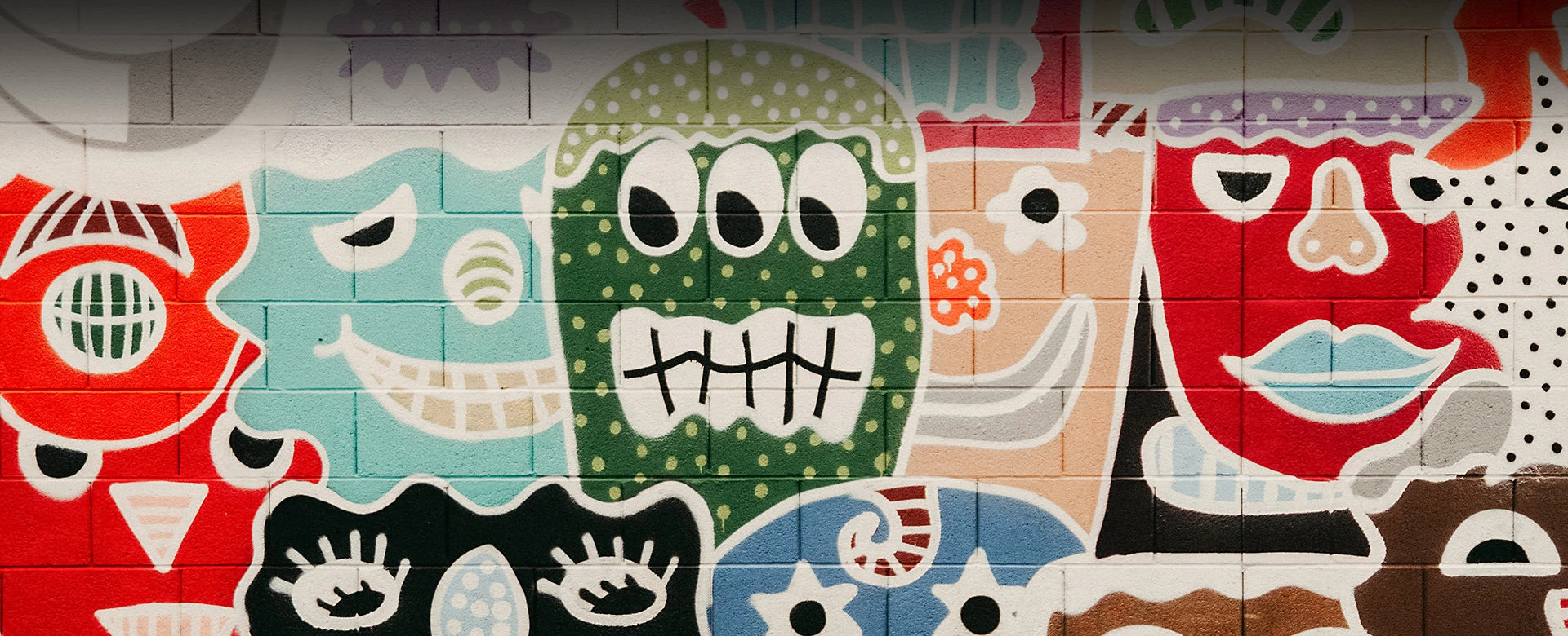 mural with collage of funky smiling faces of all colors