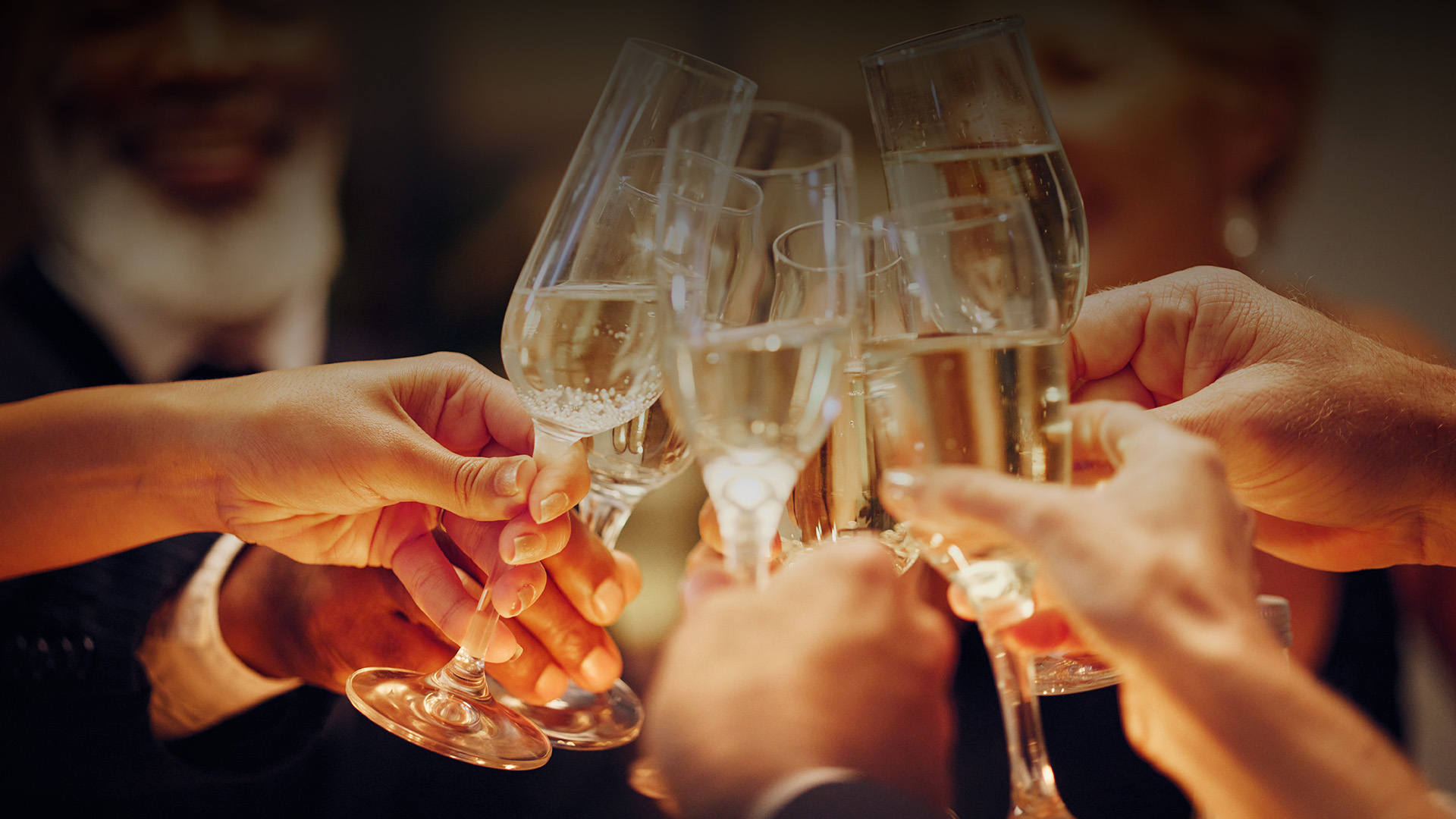 a group of people holding wine glasses