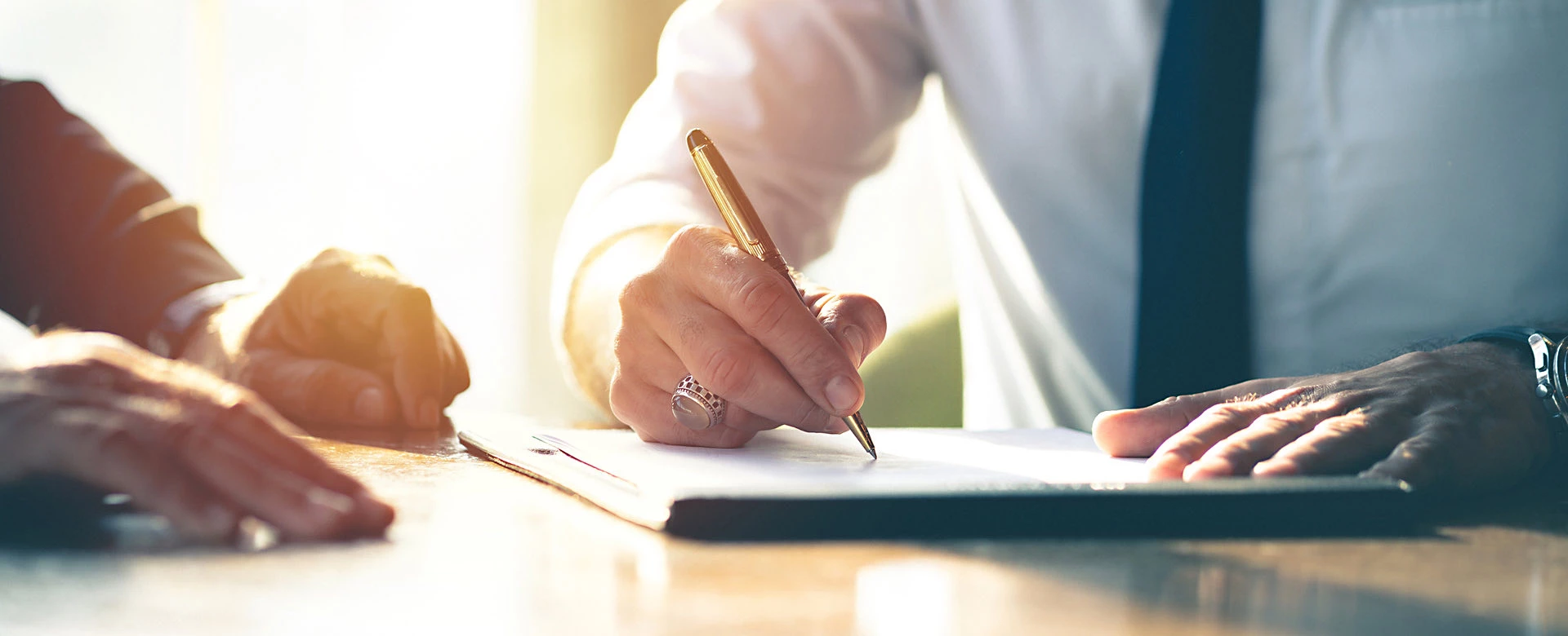 business man writing on a notepad