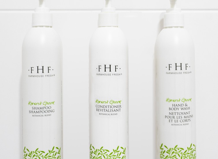 a group of white bottles with green labels