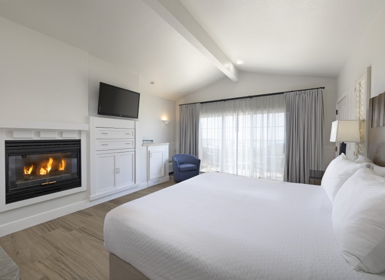 a room with a fireplace and a bed