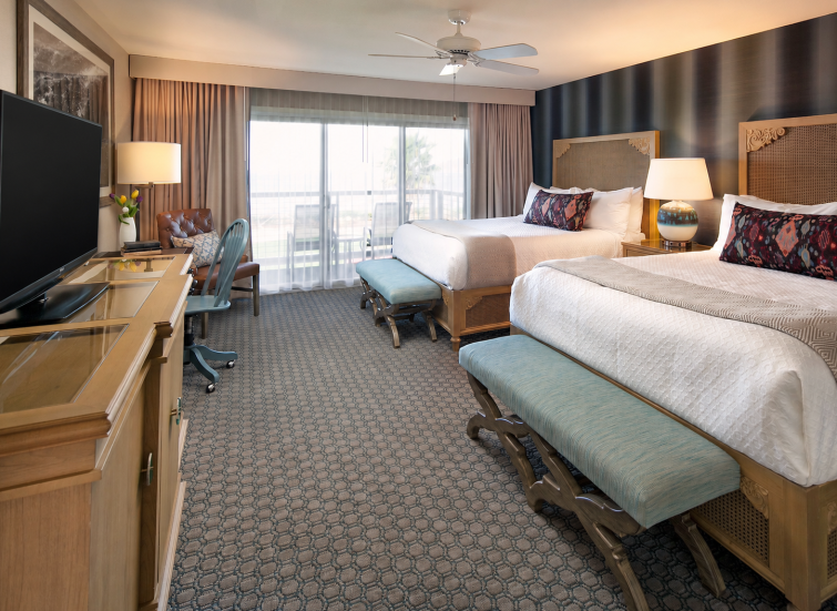a room with two beds and a desk