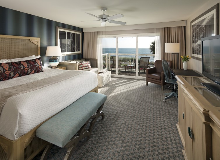 a room with a bed and a desk and chairs