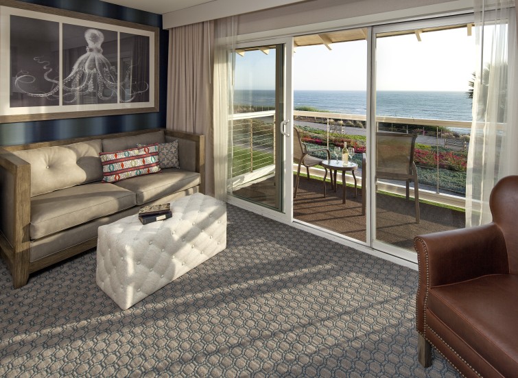 a living room with a view of the ocean