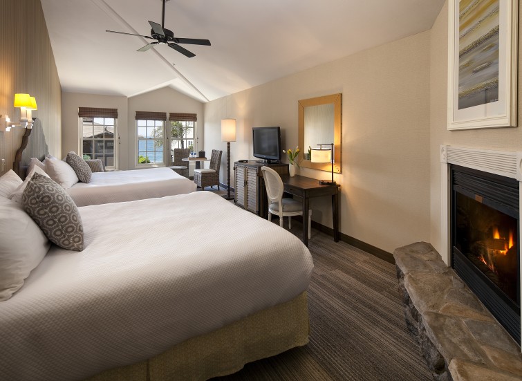 a room with two beds and a fireplace