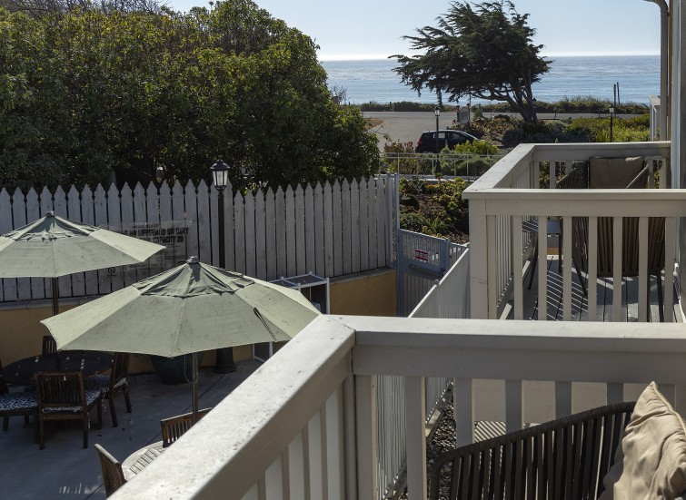 a balcony with umbrellas and trees