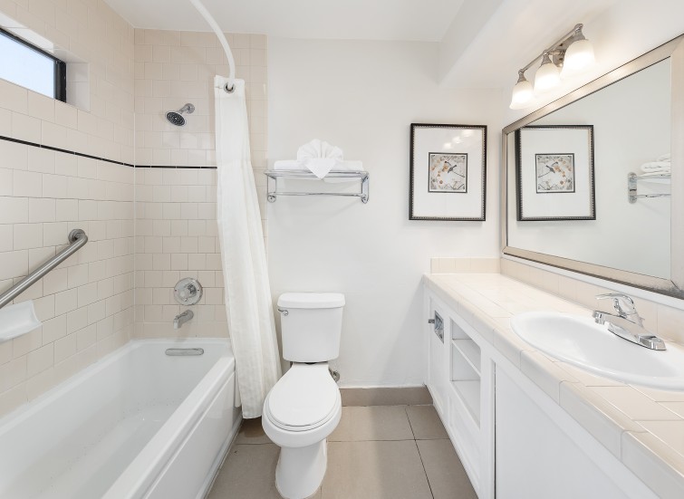 a bathroom with a white tub and toilet