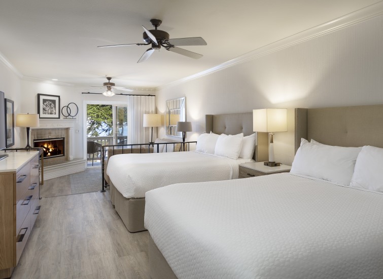 a room with two beds and a fireplace
