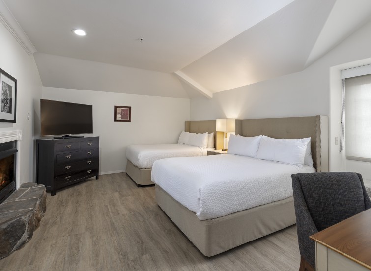 a room with two beds and a tv