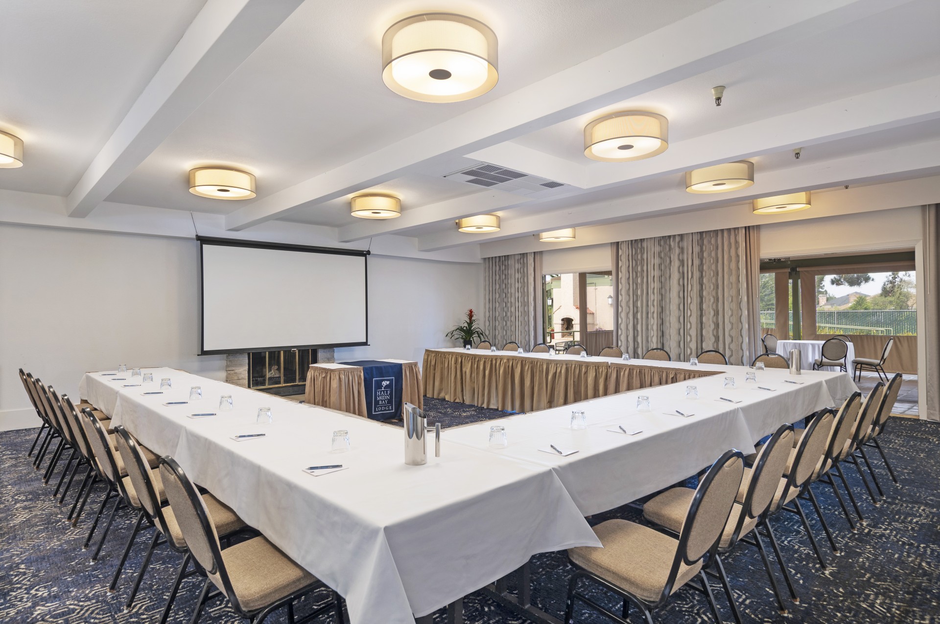 a room with long tables and chairs