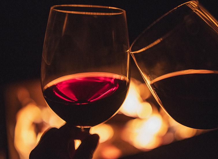 couple drinking wine by the fire
