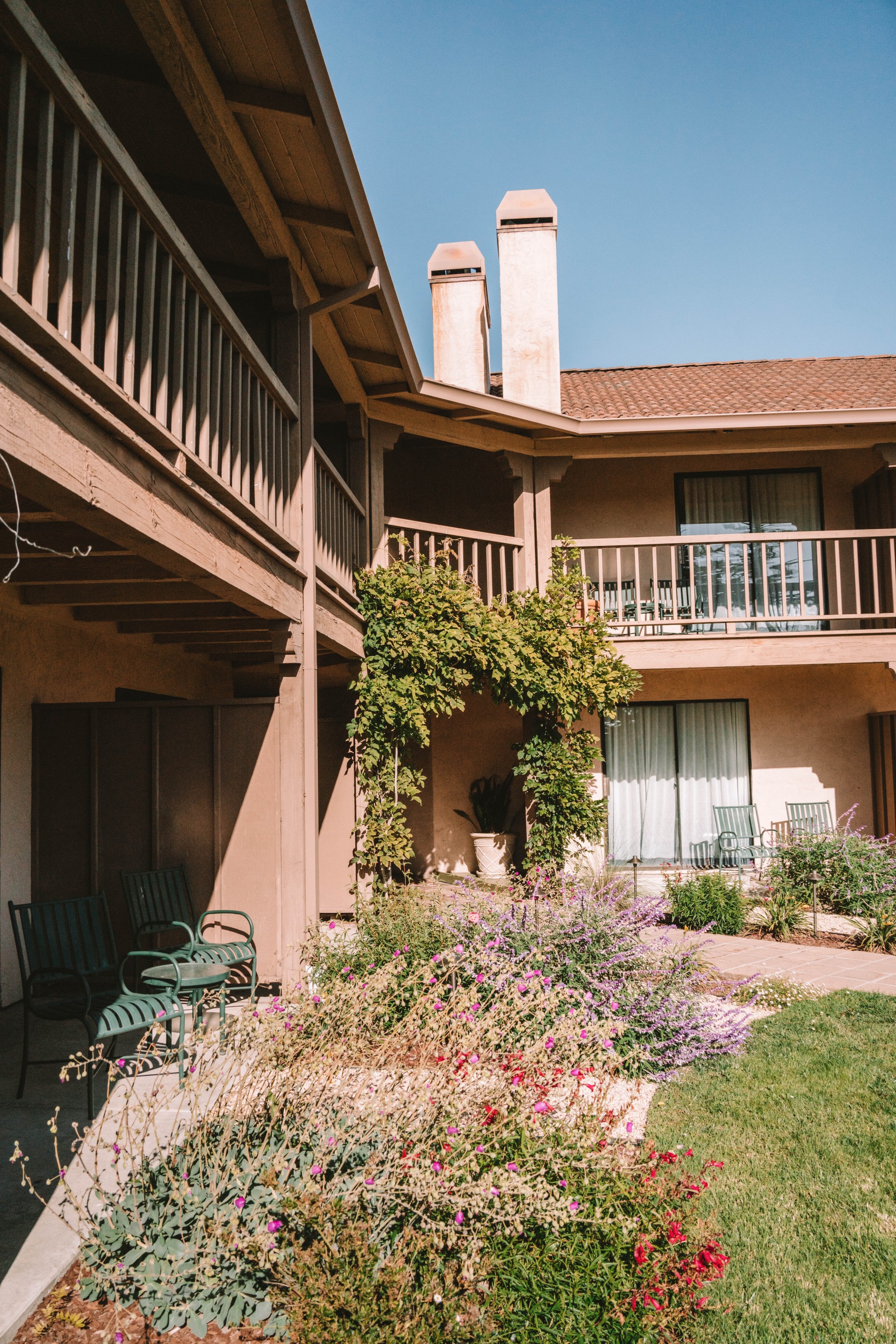 a patio with chairs and a balcony