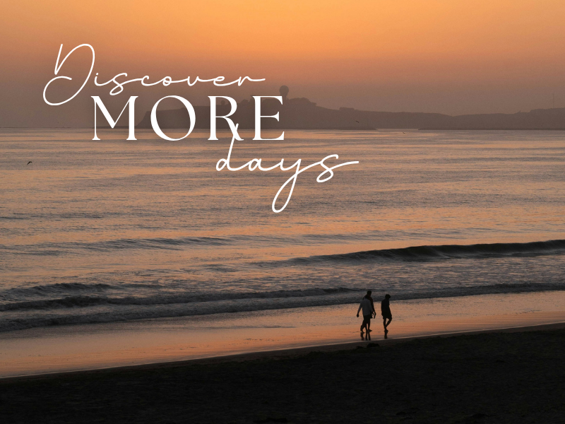 two people walking on a beach