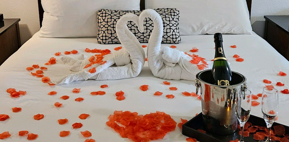 a couple of swans made from towels on a bed