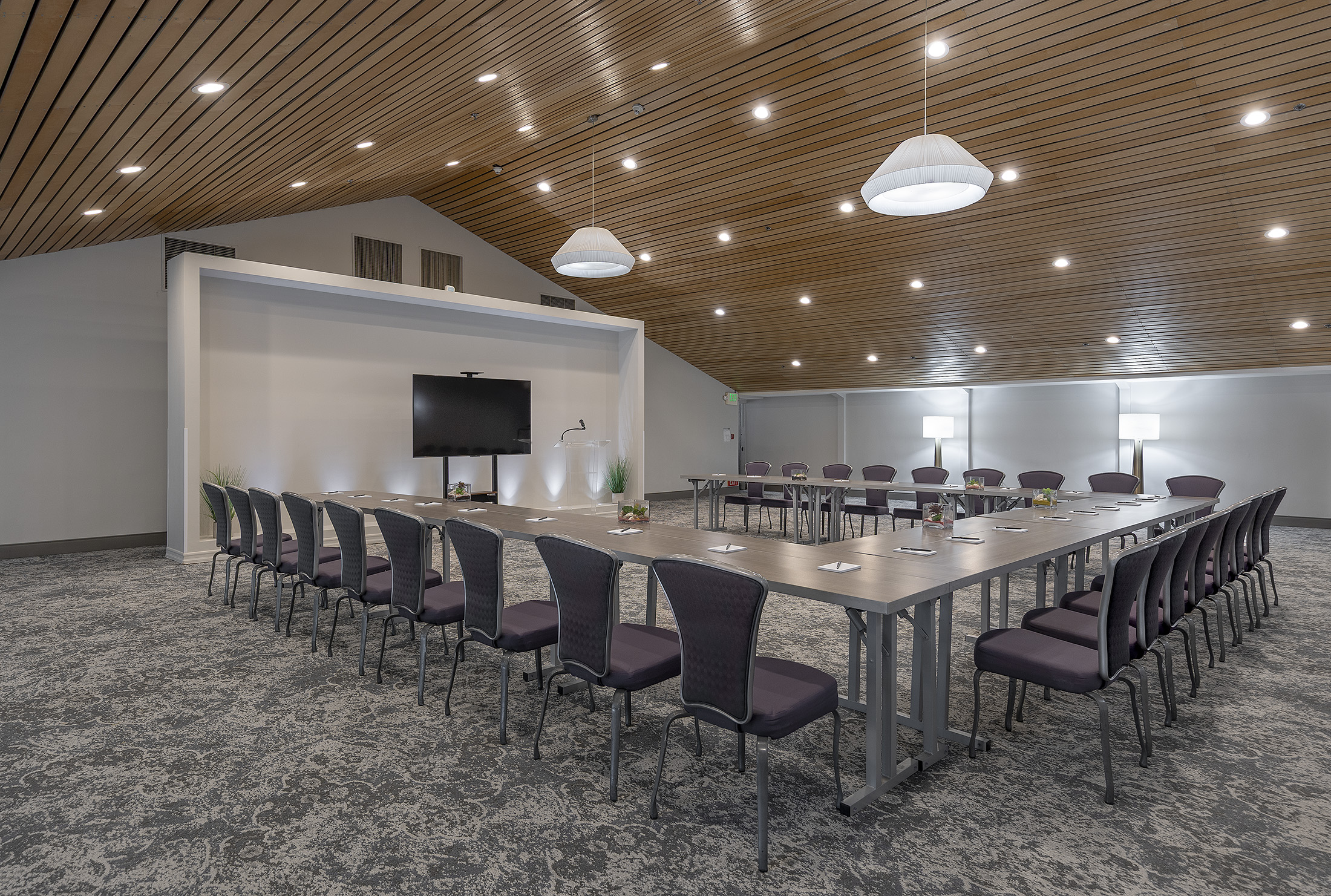 a room with a long table and chairs