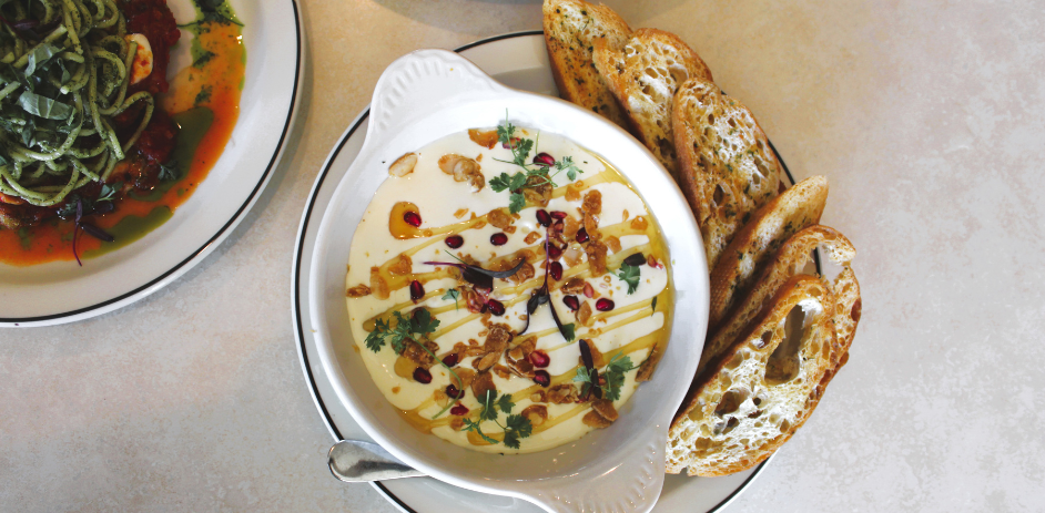 a bowl of soup with bread on a plate