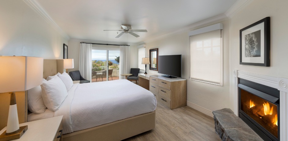 a bedroom with a large bed and a television